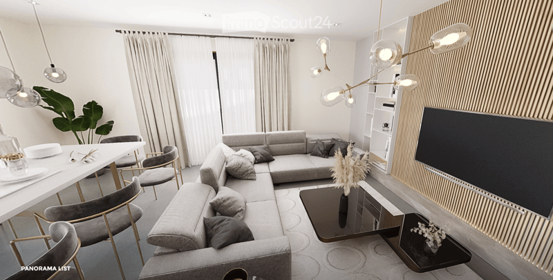 Modern living room with a grey sectional sofa, coffee table, dining table, chairs, decorative plants, and a sleek lamp fixture.