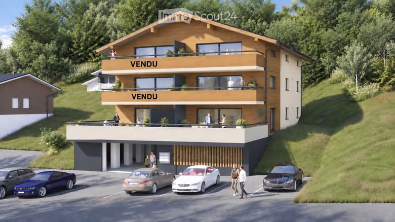 Modern two-story house with balconies, large windows, and a parking area with several cars.