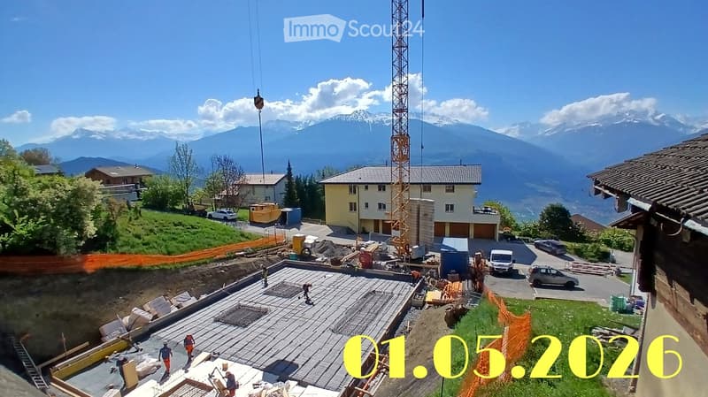 Building. A construction site with a partially built house, a crane, and a scenic mountain backdrop.