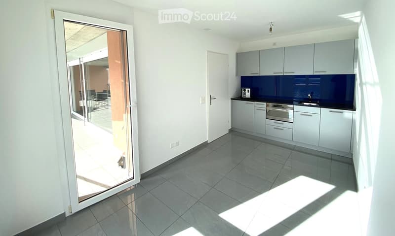 modern kitchen, sliding glass door to terrace, white cabinets, blue backsplash, under cabinet lighting, white tile flooring