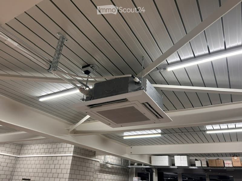 Other. Ceiling with modern linear lighting and an air conditioning unit installed, white tiled walls visible below.