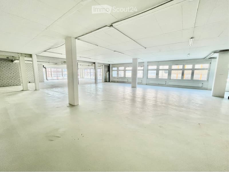 Unfurnished Room. Empty room with concrete floor, white walls, large windows, and structural columns.