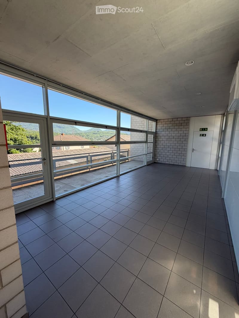 Balcony / Terrace. Empty balcony with large glass doors, tiled floor, and a scenic mountain view.