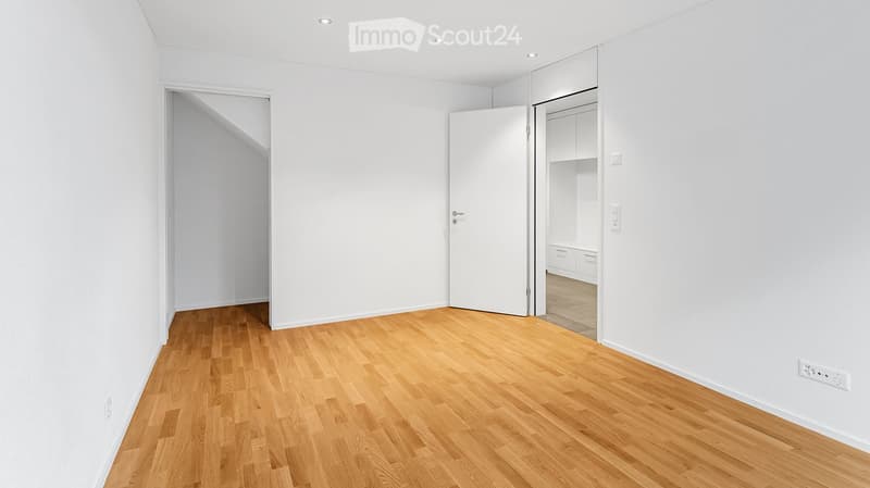 Unfurnished Room. Empty room with white walls, wooden flooring, and a closet with built-in storage. No furniture or personal items are present.