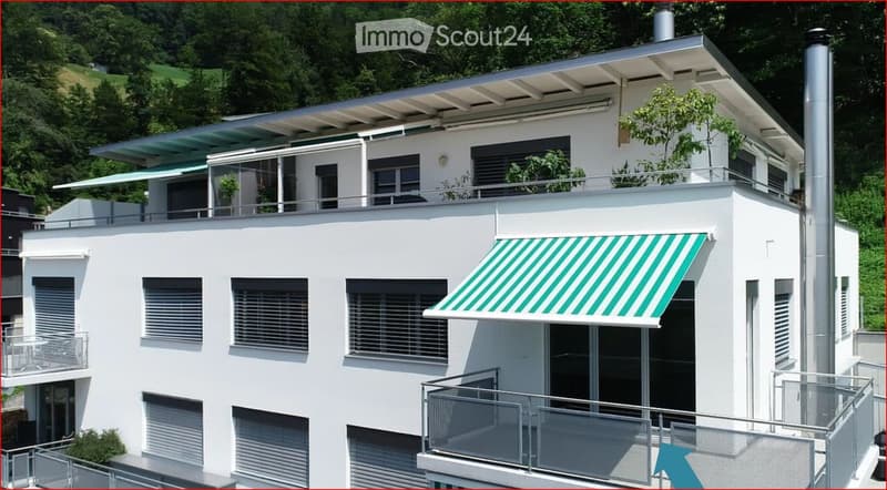 white two-story house, green awning, multiple balconies, multiple windows