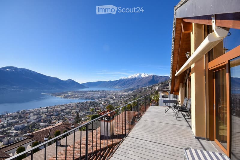 balcony with panoramic view of mountains and city