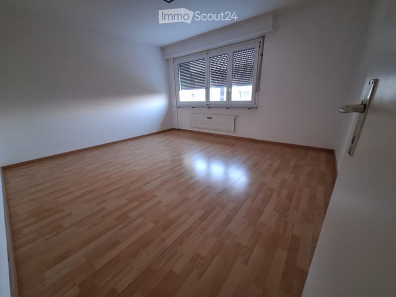 Empty room with wooden flooring, white walls, and a window with blinds. No furniture or equipment is present.