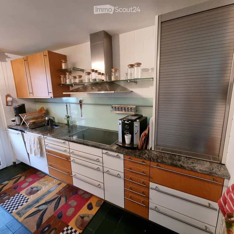 modern kitchen, granite countertop, white cabinets, wooden cabinets, stainless steel appliances, coffee machine, sink, faucet, tiled floor, rug