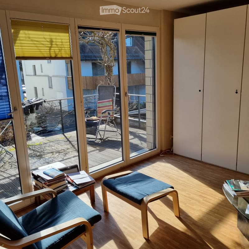 wooden floor, sliding glass doors, balcony, deck chairs, table, books, cabinet