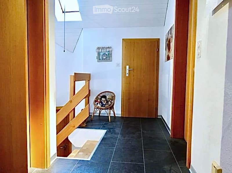 wooden door, wooden chair, wooden railing, tiled floor, picture frame