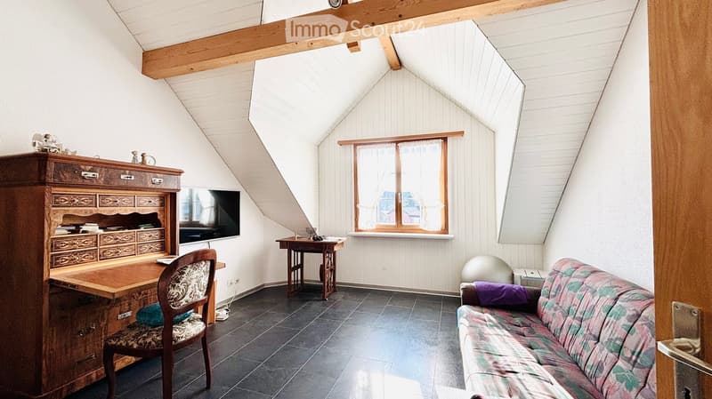 wooden desk, wooden chair, couch, television, small table, window, wooden beams