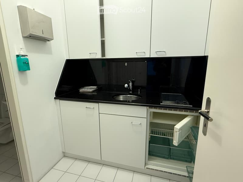 small kitchen with sink, faucet, countertop, open refrigerator, cabinets, tiled floor