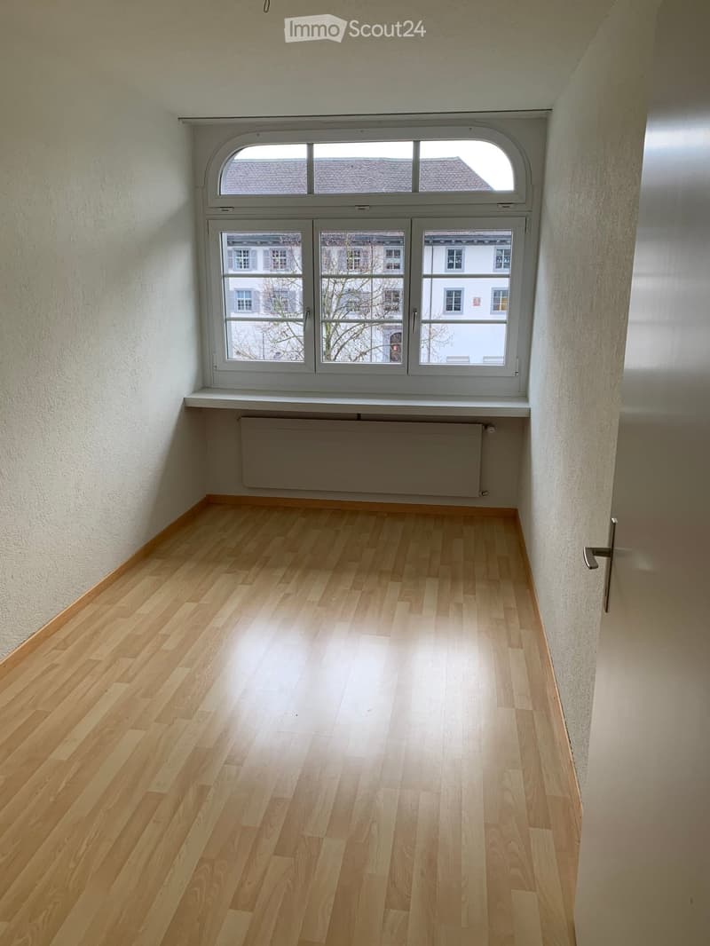empty room, large window with view, hardwood floor, white walls