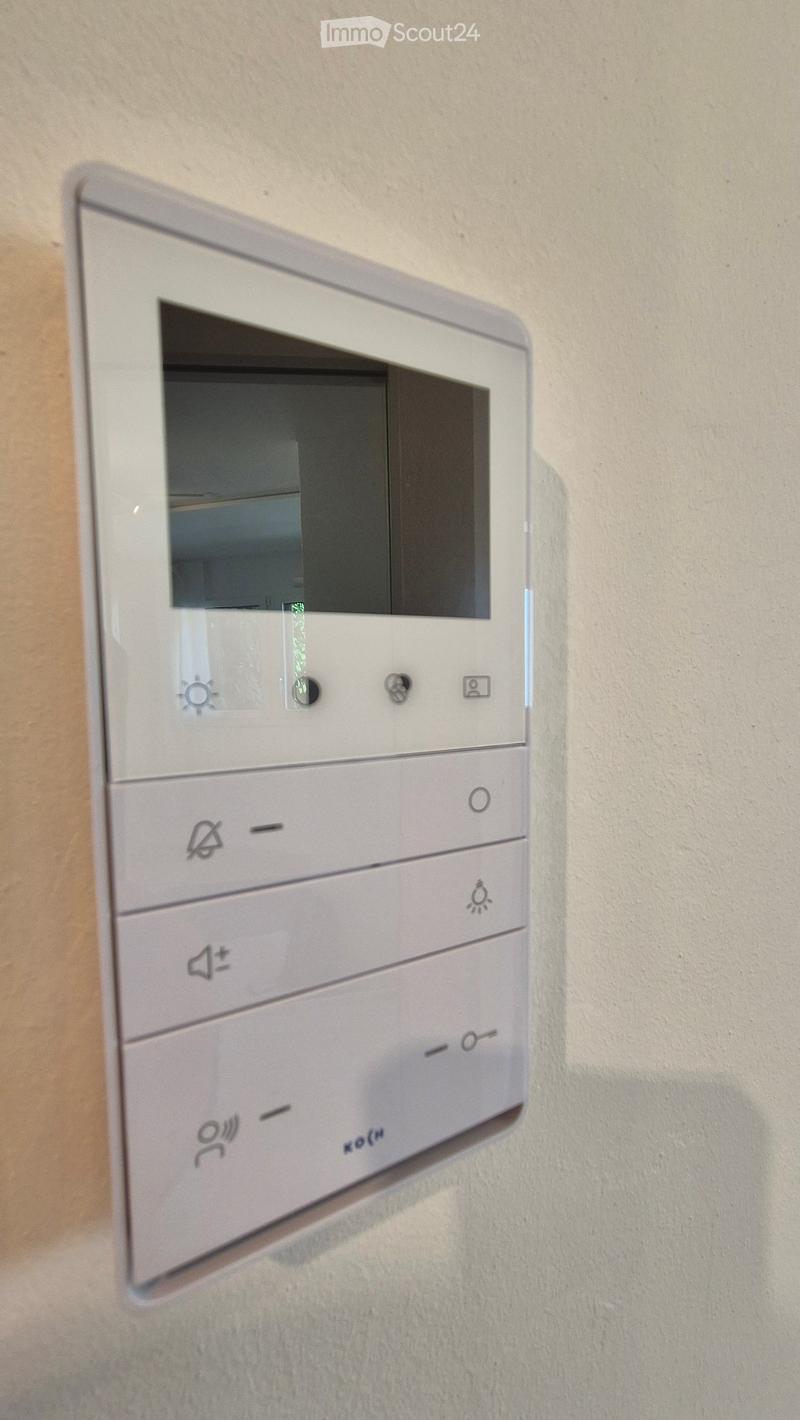 smart thermostat control panel, mounted on wall, buttons for adjusting temperature and other settings, LCD screen