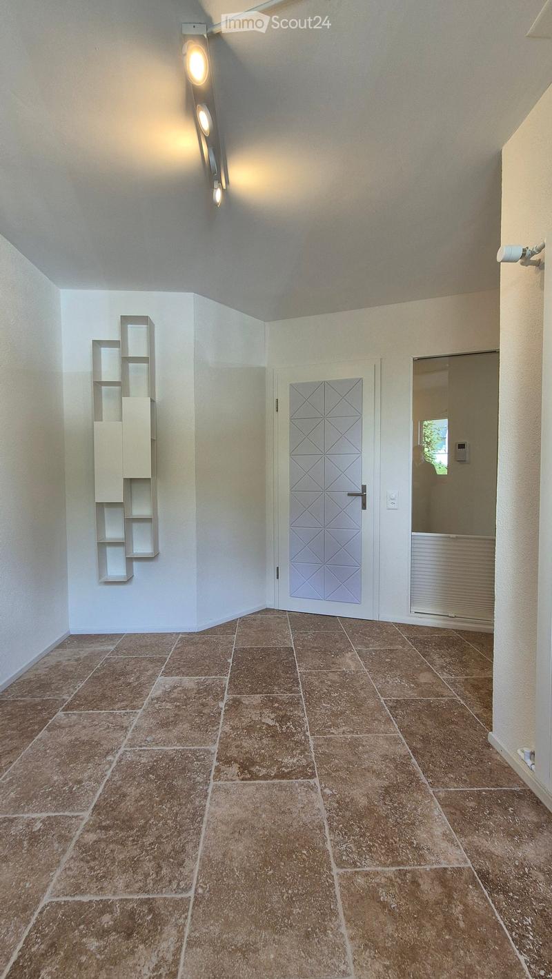 empty room, light tiles, glass doors, white shelves, modern light fixtures