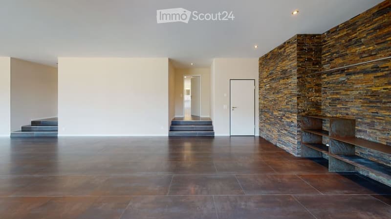Open living area with a staircase, brick accent wall, tiled flooring, white walls, doorway, metal shelves