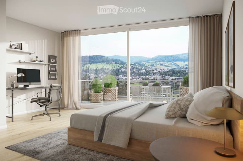 Modern bedroom with a large bed, nightstand, desk, and a scenic view of the countryside through large windows. The room features a sleek desk setup with a computer and chair, shelves with picture frames, and potted plants on the balcony.