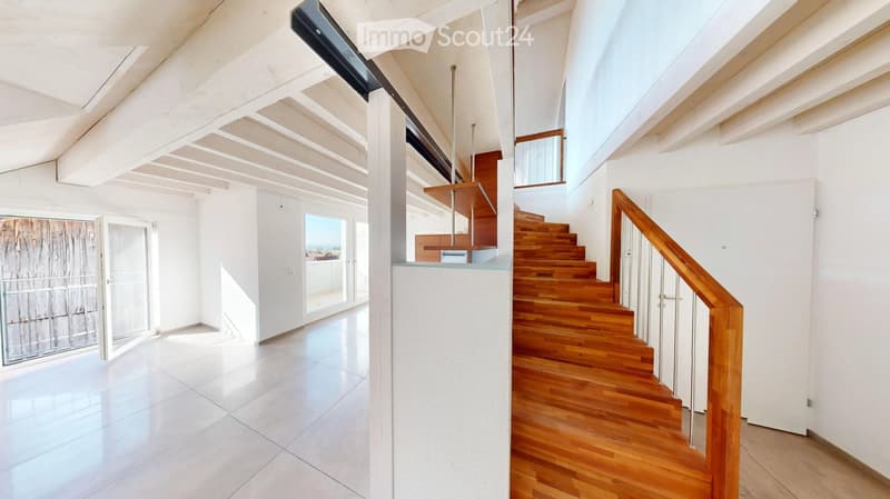 Modern, bright hallway with white tiled floor, wooden staircase, and large windows offering a view.
