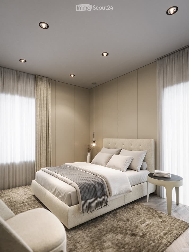 King-size bed, nightstand, cozy armchair, beige carpet, neutral wall colors, ceiling lighting, pendant lamp, large windows with white curtains