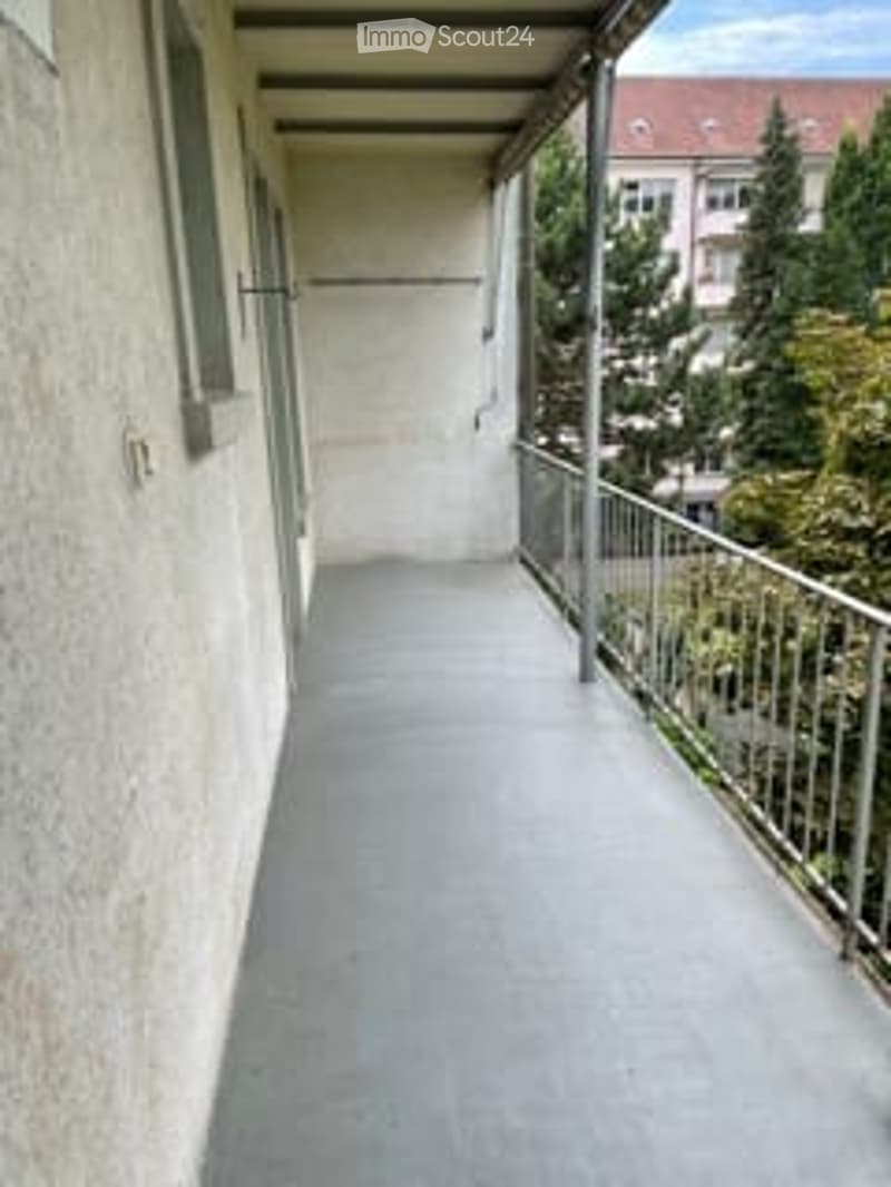 Empty balcony, metallic railing, covered, concrete floor