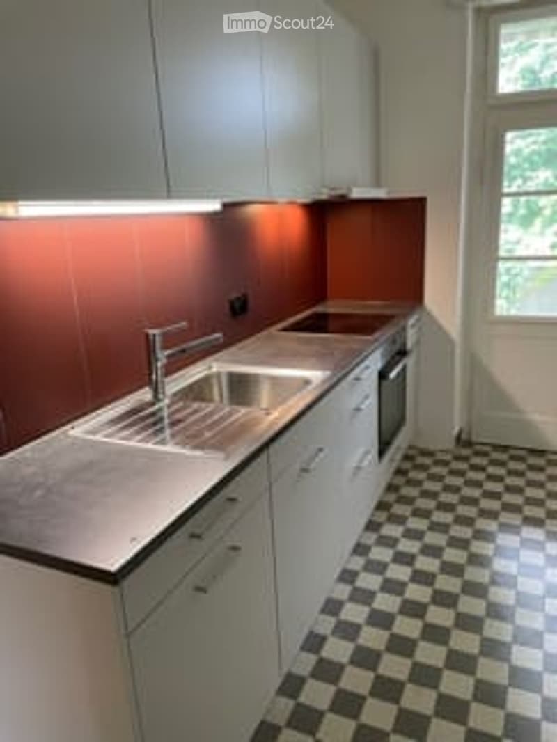 modern kitchen with white cabinets, stainless steel countertops, integrated sink, faucet, gas stove, dishwasher, tiled floor