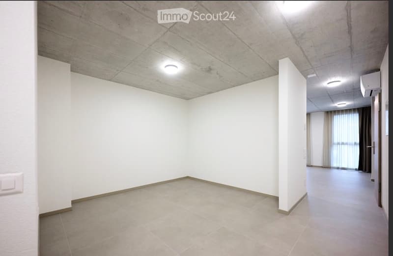 Empty room with white walls, tiled floor, and recessed lighting. No furniture or equipment present.