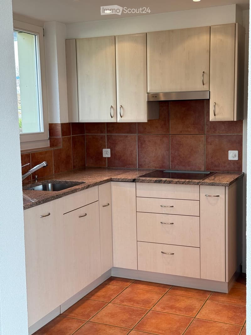 white cabinets, granite countertops, sink, built-in oven, under-cabinet drawers, power outlets