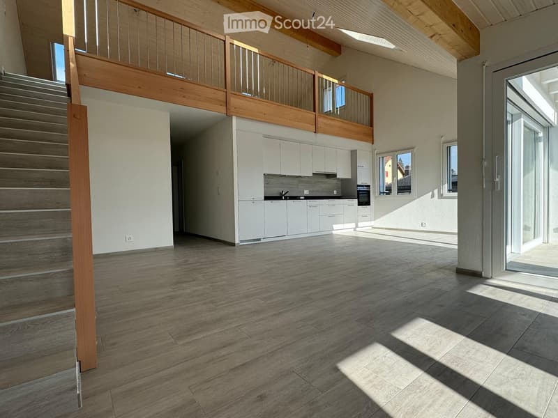 open floor plan, kitchen, balcony, stairs, large windows