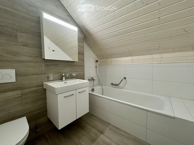 Bathroom with wooden floor, white walls, white bathtub, white sink, mirror, toilet, shower