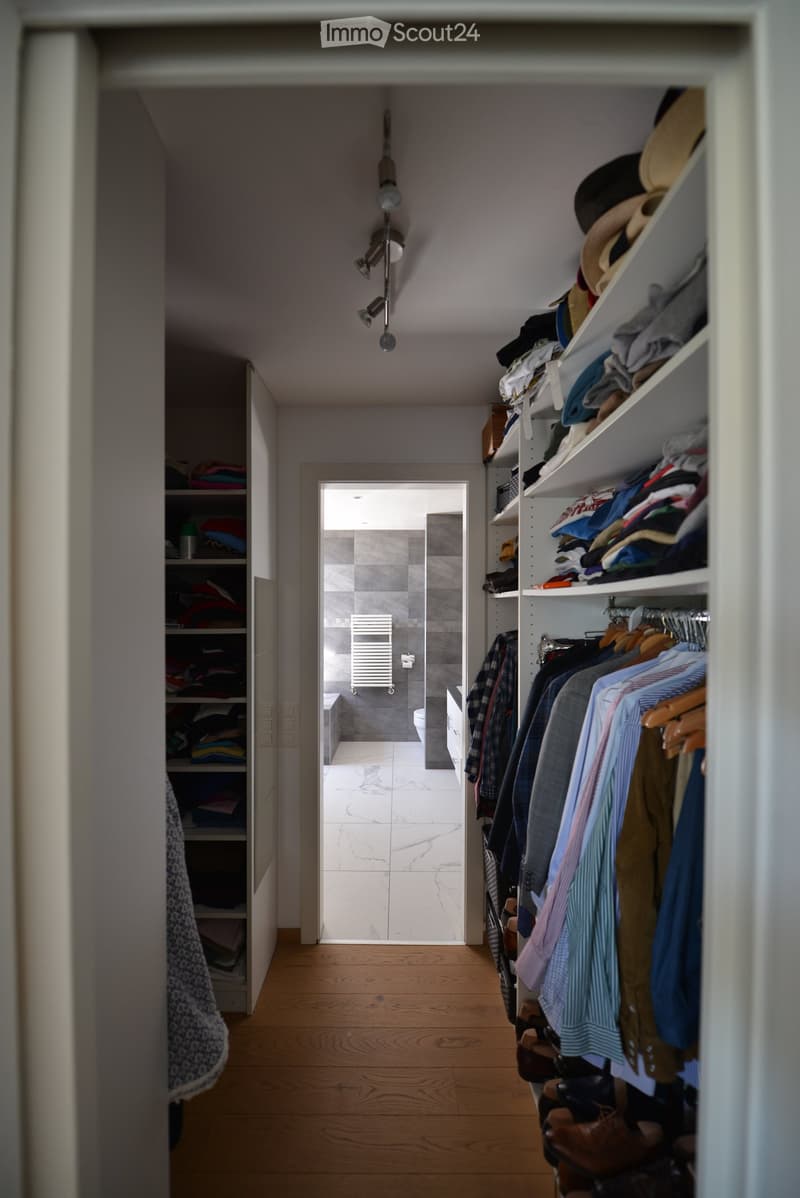 {"visible_features": [], "type": "Furnished Room", "objects": ["clothes", "shoes", "hats", "toilet", "toilet paper", "clothes rack", "clothes hangers", "shelf", "clothes", "clothes", "clothes", "clothes", "clothes", "clothes", "clothes", "clothes", "cloth