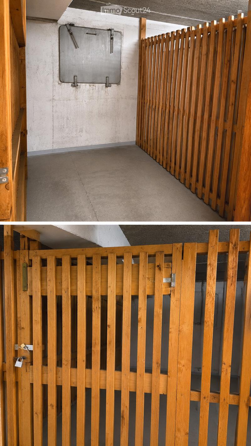 Empty hallway with wooden railings and a metal door, concrete walls and floor.