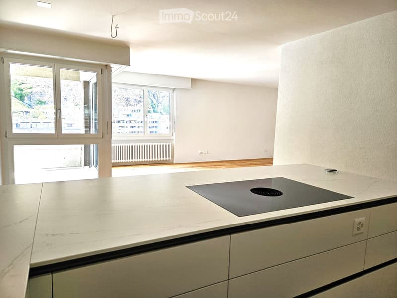 Modern kitchen with a large window that offers a scenic view of the outdoors.