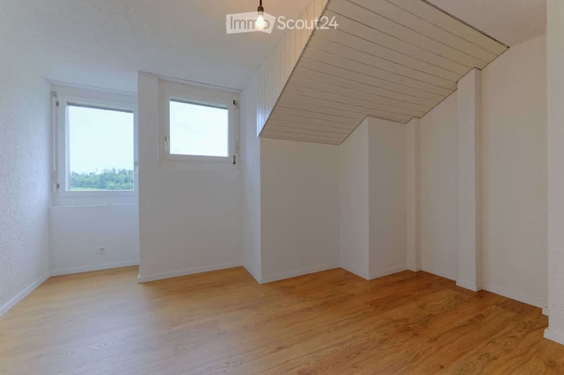 empty room, wooden floor, white walls, two windows, slanted ceiling