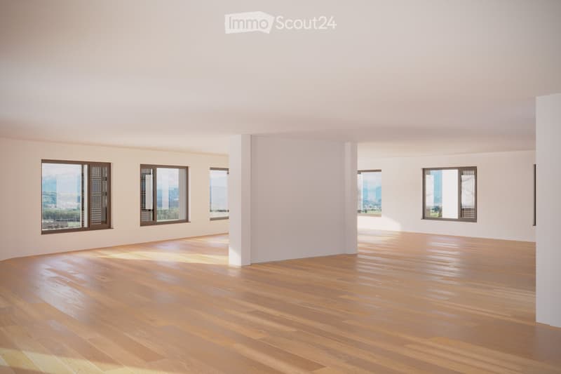 Empty room with wooden flooring and large windows offering a view of the city and mountains.
