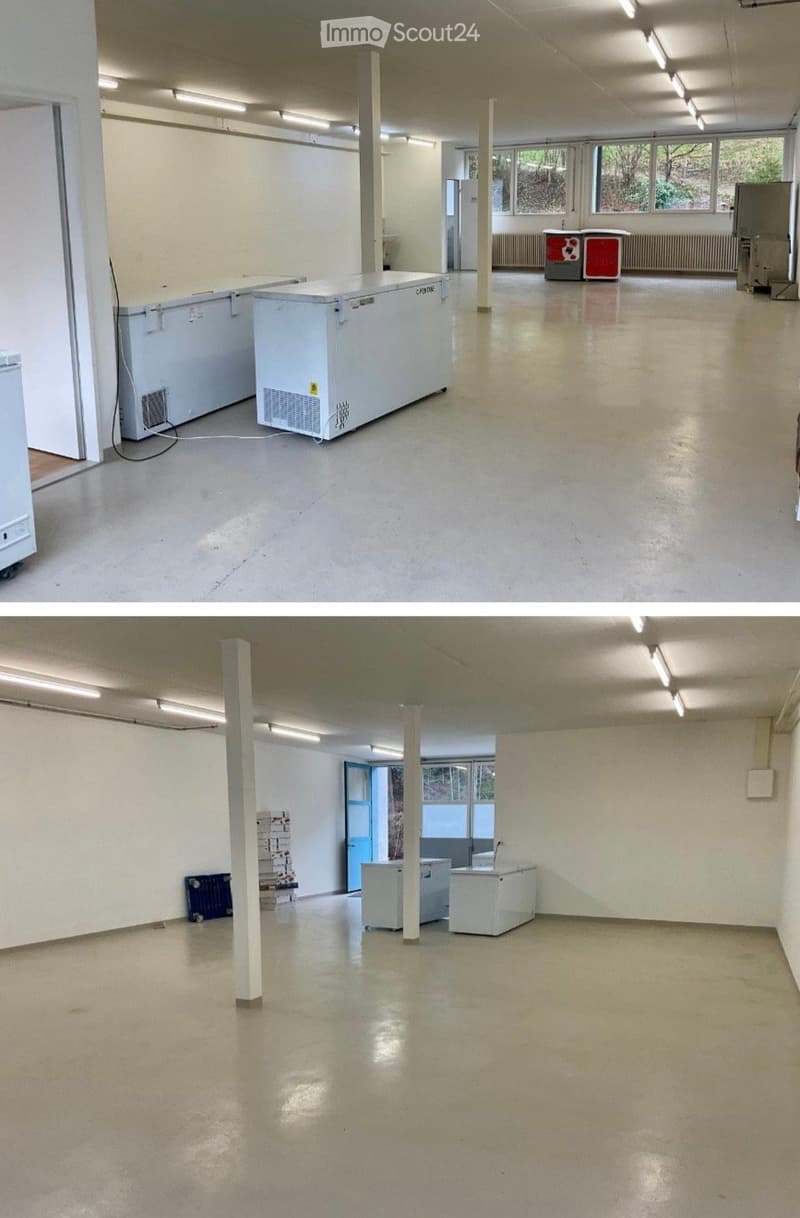 Empty room with white walls, polished concrete floor, fluorescent lighting, and industrial-style columns. Minimal furnishings include a few large white storage units and a small blue crate.
