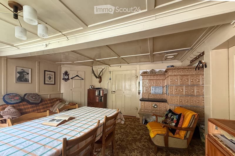 dining table, sofa, bookshelves, vintage lamps, fireplace, open door