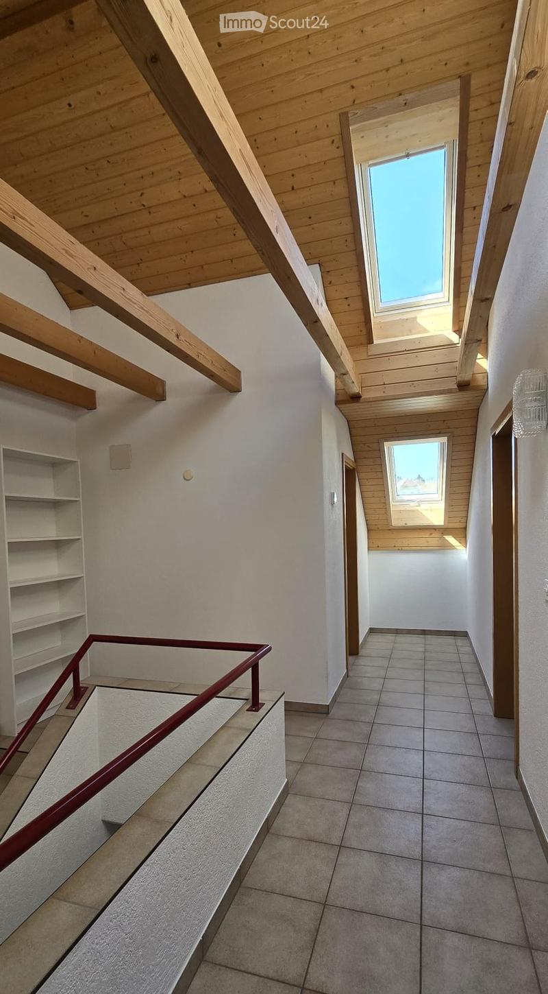 empty room, wooden ceiling, tiled floor, white walls, two skylights, white shelf, red handrail