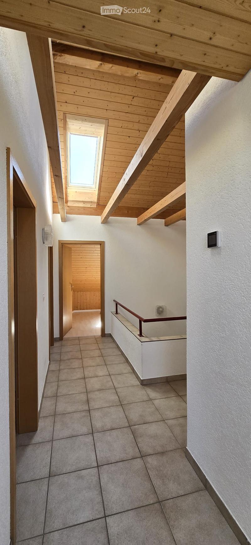 tiled floor, wooden ceiling, skylight, hallway leading to rooms