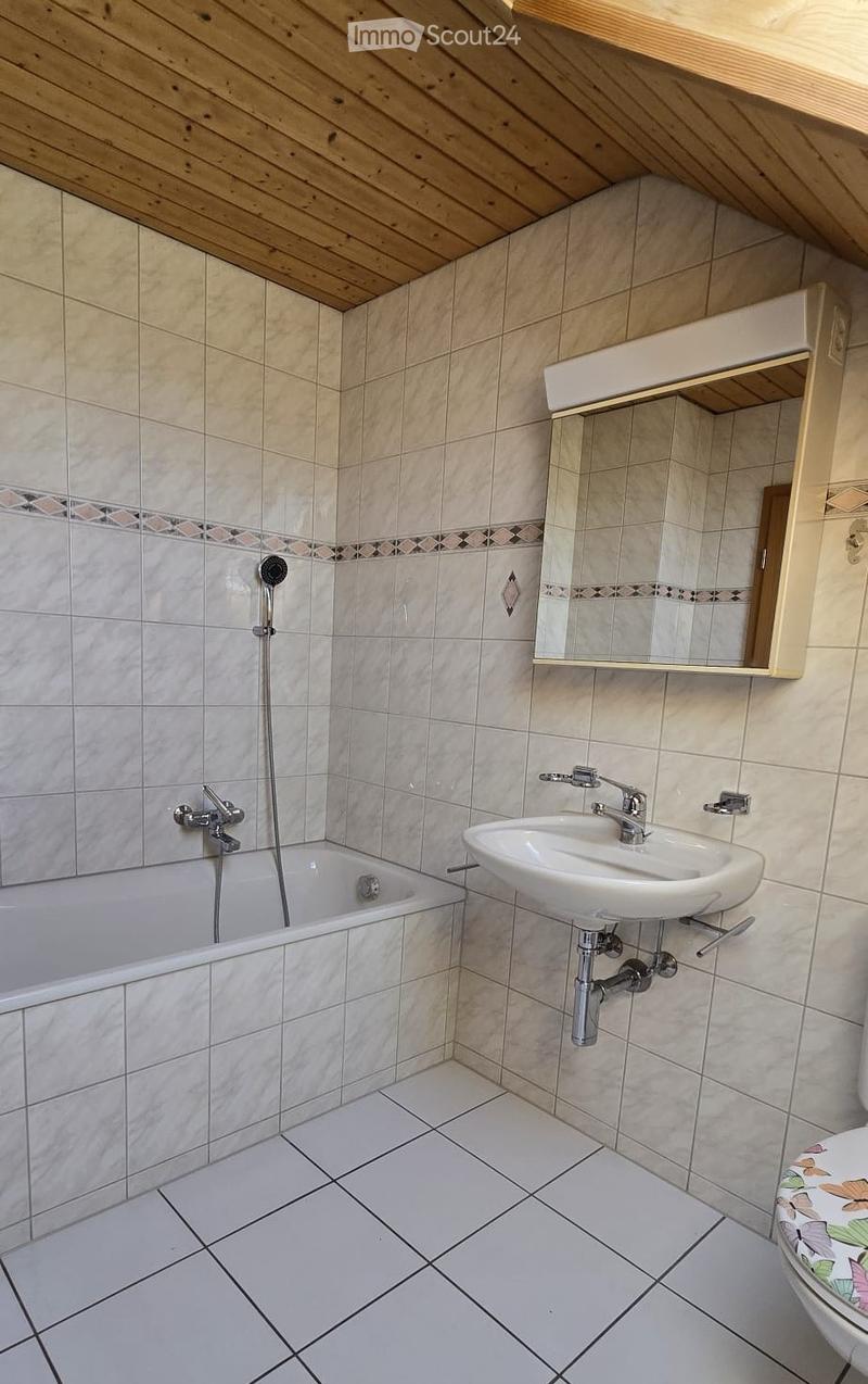 Bathroom with bathtub, sink, mirror, and toilet