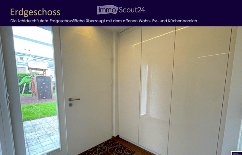 Empty room with white walls, wooden floor, white closet, and a small patterned rug near the door. The door leads to an outdoor area with a playground visible.