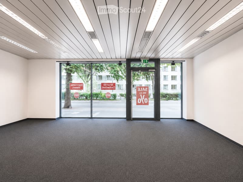 Empty room with carpeted floor, white walls, and large glass doors leading to an outdoor area.