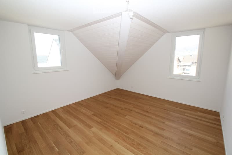{"visible_features": [],    "type": "Room",    "description": "room with wooden floors, white walls, two windows, slanted roof",    "localized_descriptions":        {        "EN": "Room with wooden floors, white walls, two windows, slanted roof",
