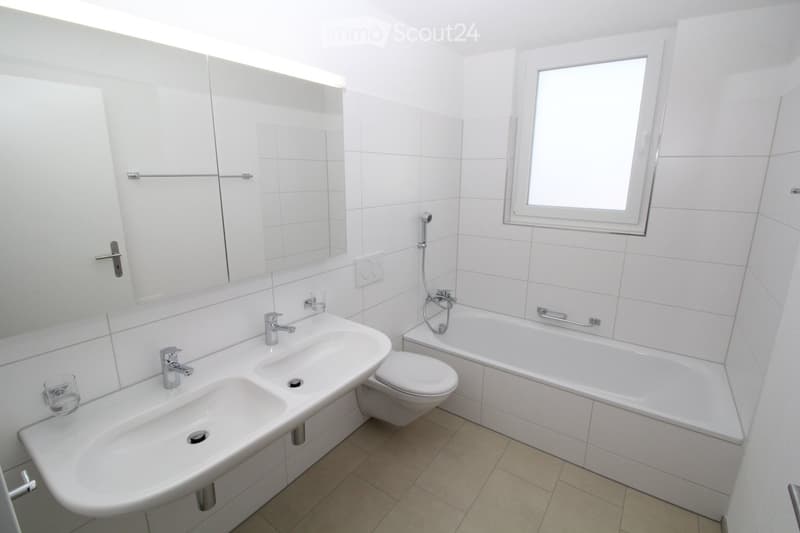 Double sink, bathtub, toilet, shower, large mirror, window
