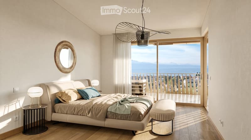 Modern bedroom with a large bed, nightstands, a round mirror, and a view of the sea through large windows and a balcony.