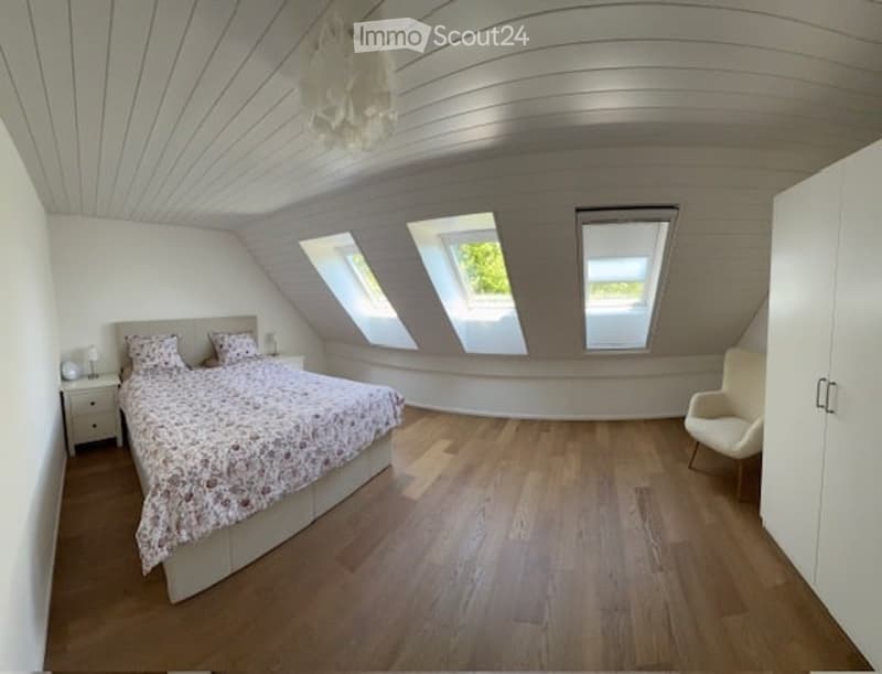 bedroom with bed, chair, and 3 roof windows