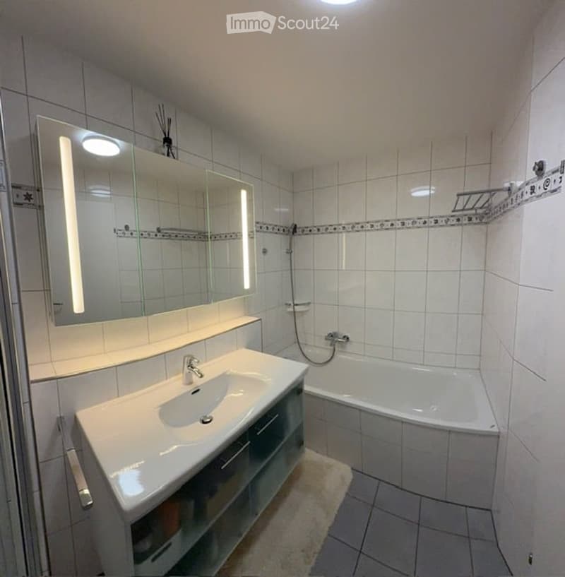 Bathroom with white walls, tiled floor, shower, bathtub, vanity, and mirror