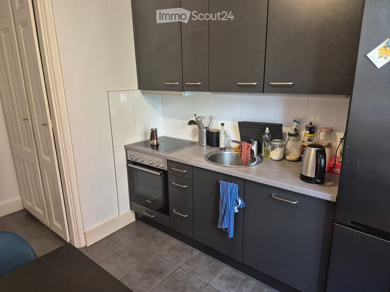 {"type": "Kitchen", "objects": ["oven", "sink", "faucet", "refrigerator", "kitchen cabinets", "electric kettle", "oven mitt", "cupboard", "bottle", "cup", "faucet", "oven", "oven mitt", "cupboard", "cupboard", "cupboard", "cupboard", "cupboard", "cupboard