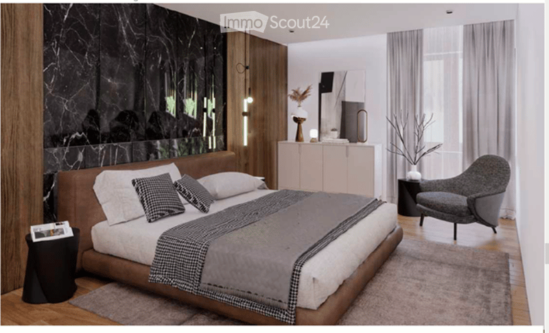 Modern bedroom with a large bed, nightstand, armchair, and a sleek cabinet. The room features a marble accent wall and large windows with sheer curtains.