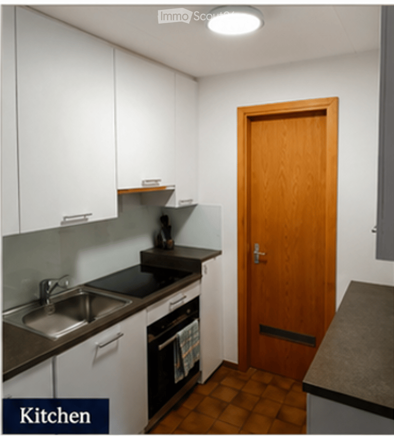 Modern kitchen with white cabinets, stainless steel sink, oven, and wooden door.