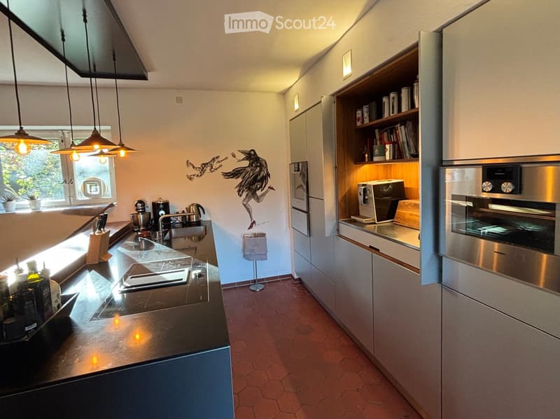 Kitchen with an island, modern appliances, tiled floor, decorative painting on the wall